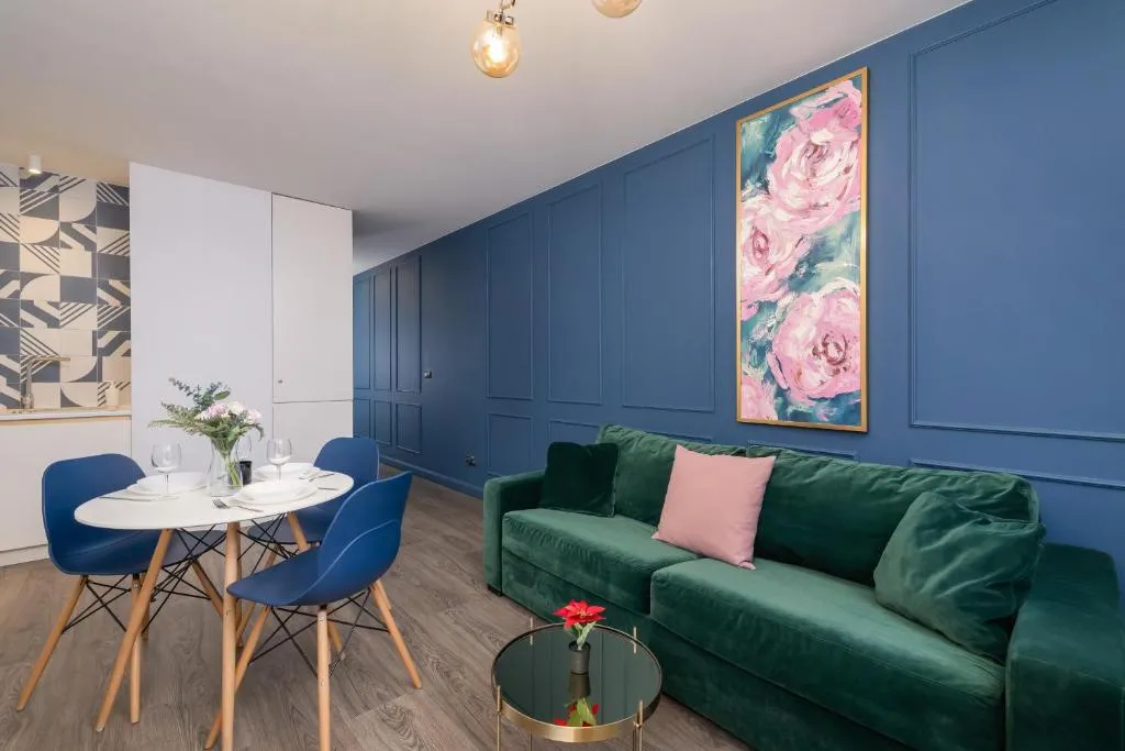 Image of Blue and Green Apartment with Bright Pink Bedroom in Kraków by Noclegi Renters